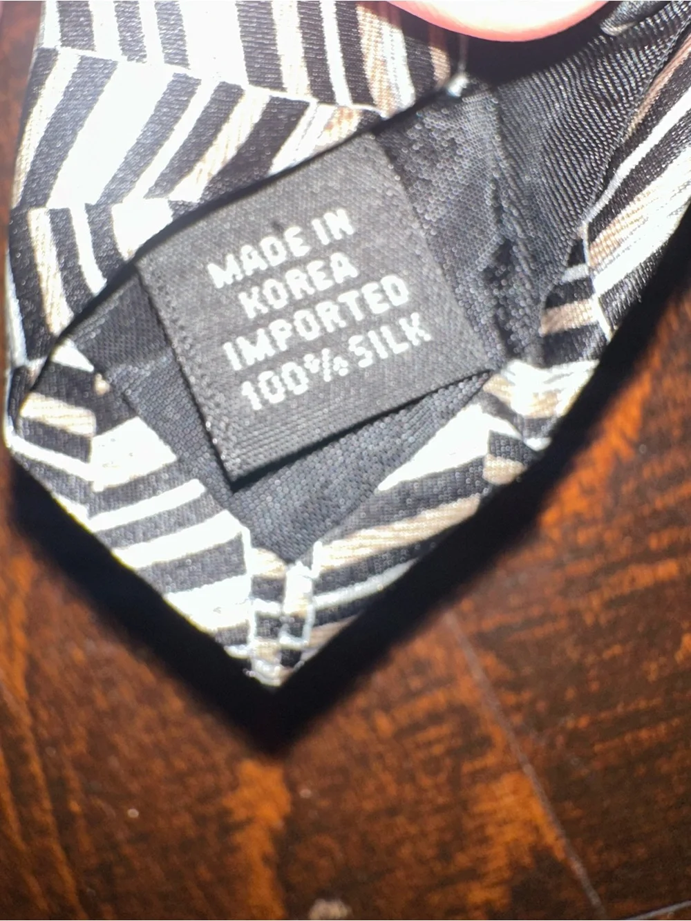 VAN Heusen necktie features black, beige, and grey geometric herringbone pattern